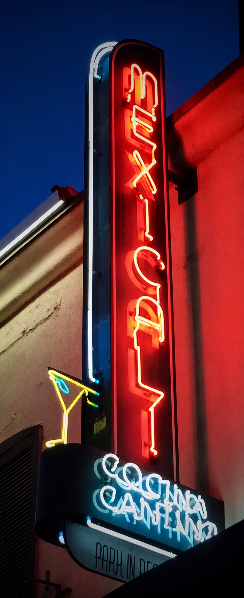 The landmark vertical Mexicali neon sign illuminated against the night sky